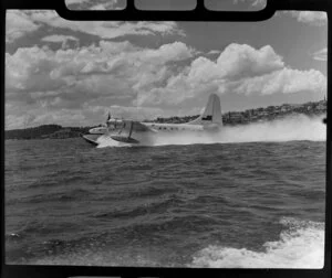 The Tasman Empire Airways Limited Short Solent flying boat RMA Ararangi (ZK-AMM) landing in Sydney Harbour, Australia