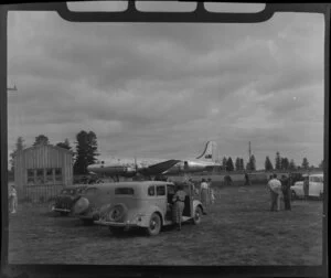 People and cars outside the airport, with a Qantas Empire Airlines aircraft waiting, Norfolk Island
