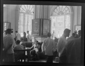 Crowded room [Bar? Office of J Matheson?] including British Overseas Airways Corporation posters and Air France printed on the windows with leadlight detailing