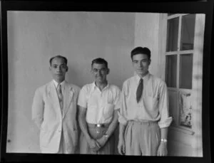 Leo Lemuel White (centre) and two unidentified local men in front of a door, Hong Kong