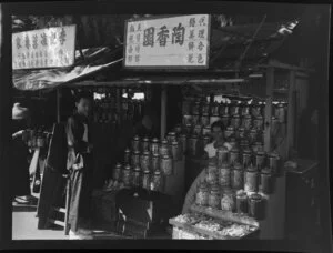 Street vendor selling sweets and biscuits at his stand, Aberdeen Harbour area, Hong Kong