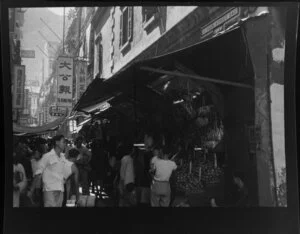 Busy street scene, Hong Kong, featuring fruit stall
