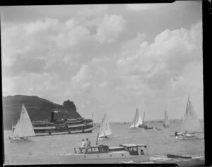 Spectators crowded on an Auckland ferry to watch the 18 footer yacht race, 100th Anniversary Day regatta, Auckland Harbour