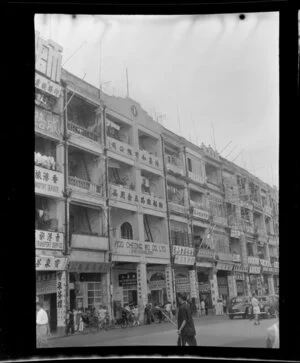 Street scene, Hong Kong, featuring businesses such as Wing Maw Sang Kee (passenger agents for Indo China) and Hoo Cheong Wo Co Ltd (Ship Chandlers)