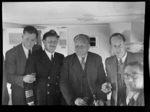 Unidentified newspaper representatives with Captain Griffiths on board the Tasman Empire Airways Ltd Short Solent flying boat, Sydney to Auckland flight