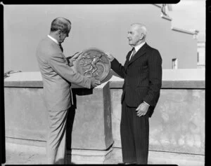 An unidentified man receiving a plaque for 25 years of service to Austin Motors from Seabrook Fowlds Ltd, Auckland