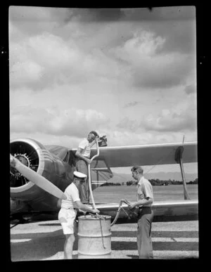 Unidentified Auckland Aero Club members refuelling a plane at Kaikohe Airport, Far North District, Northland Region