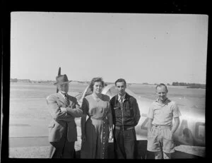 French visitors to the Auckland Aero Club in front of an airplane, Mangere Aerodrome, Manukau City, Auckland Region