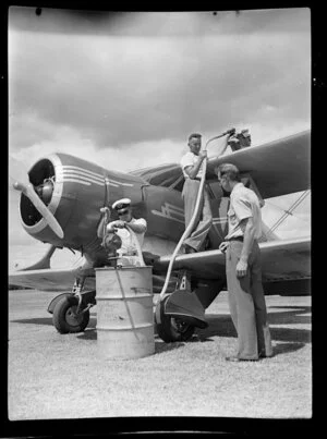 Unidentified Auckland Aero Club members refuelling a plane at Kaikohe Airport, Far North District, Northland Region
