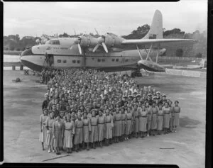 Group of Tasman Empire Airways Ltd staff standing alongside the Solent IV flying boat RMA Awatere, ZK-AMN