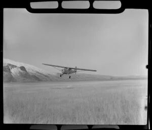 Austen aircraft coming to land on tussock, Mount Cook Hermitage, MacKenzie District