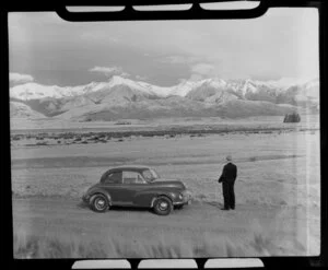 Unidentified man with Morris Minor, Manapouri region, Southland district