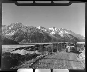 Mt Cook and Southern Lakes Tourist Company Ltd bus, including Mt Cook in the background