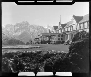 Mt Cook and Southern Lakes Tourist Company Ltd bus at The Hermitage Hotel, including Mt Cook in the background
