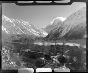 Mt Cook and Southern Lakes Tourist Company Ltd bus, including Mt Cook in the background