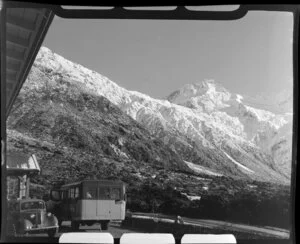 Mt Cook and Southern Lakes Tourist Company Ltd bus at The Hermitage Hotel, imcluding Mt Cook in the background