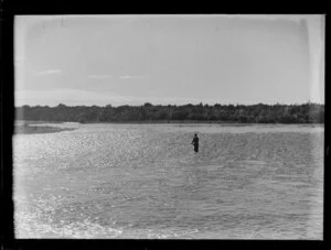 Fisherman fishing for trout in unidentified river