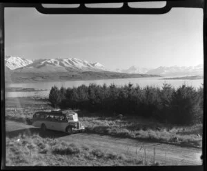 Mt Cook and Southern Lakes Tourist Company Ltd bus, including Lake Pukaki and Mt Cook in the background