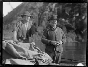 Two unidentified whalers, both who wear hats and one of whom who is smoking, Bay of Islands, Far North District, Northland Region