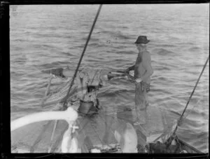 Unidentified whaler with harpoon gun on board whaling boat, Bay of Islands, Far North District, Northland Region