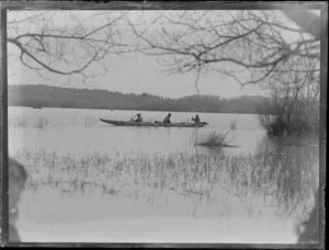 Duck shooting, featuring three unidentified hunters in boat, location unknown