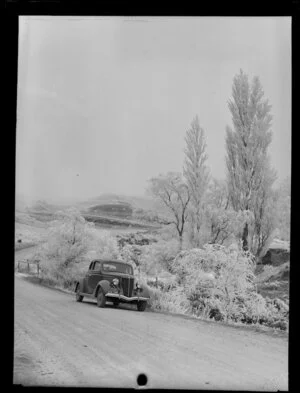 Snowy rural scene, Otago Region, including parked car