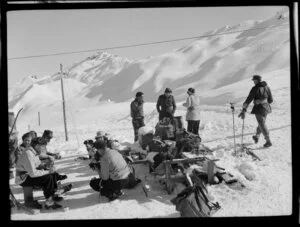 Skiers, sitting in the snow, Coronet Peak Ski Field, Central Otago