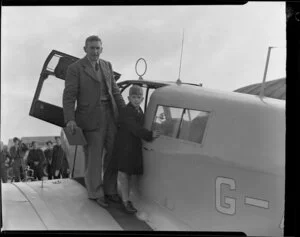 Captain Bradshaw with his son on the arrival of Captain Bradshaw at Whenuapai airport