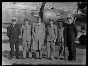 Captain Burgess with National Airways Corporation and British Commonwealth Pacific Airlines officers beside the aircraft RMA Endeavour at Whenuapai