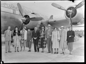 Group of people standing beside the British Commonwealth Pacific Airlines aircraft RMA Endeavour at Whenuapai before White's Fijian tour