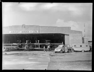 Aircraft and truck outside the hangar of Aircraft Service (NZ) Ltd, Auckland