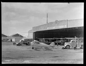 Aircraft and trucks outside the hangar of Aircraft Service (NZ) Ltd, Auckland