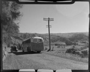 Landliner coach and car on the road near Mangaweka, Rangatikei district