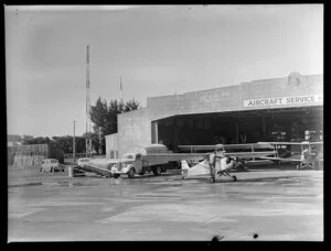 Aircraft and truck outside the hangar of Aircraft Service (NZ) Ltd, Auckland