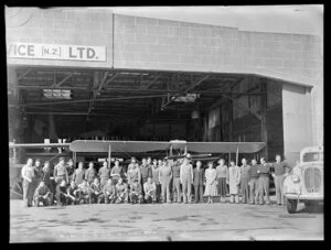 Staff of Aircraft Service (NZ) Ltd outside the hangar, Auckland