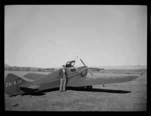 Harry Wigley beside a Miles Whitney Straight aircraft, Timaru