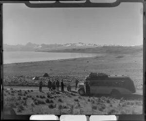 Tourists from a Mount Cook and Southern Lakes Tourist Co coach looking at Lake Pukaki, MacKenzie District