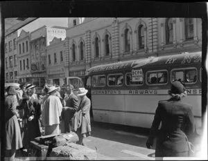 Unidentified group waiting at a Johnston's Airways Transport bus in Auckland at the beginning of White's Fiji tour