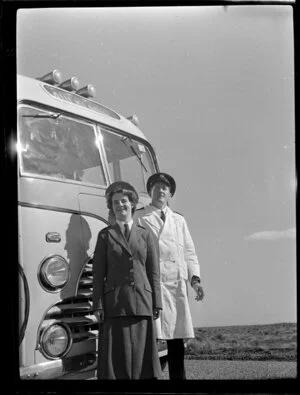 Driver and hostess in front of the Luxury Landliner coach, Tongariro National Park