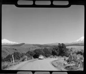Morris Minor on the Desert Road with Mount Ngauruhoe and Mount Ruapehu in the background