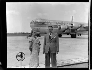 Pan American World Airways, unidentified couple standing in front of a Stratocruiser aircraft at Whenuapai Airbase, Auckland