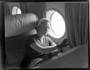 Pan American World Airways, unidentified woman aboard aircraft at Whenuapai Airbase, Auckland
