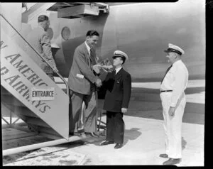 Pan American World Airways, unidentified man being greeted by a crew member at Whenuapai Airbase, Auckland