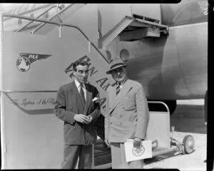 Pan American World Airways, unidentified men standing in front of a Stratocruiser aircraft at Whenuapai Airbase, Auckland
