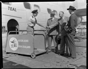 TEAL staff member shakes hands with representatives of New Zealand Forest Products at aeroplane door