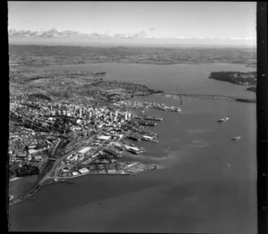 Auckland City looking towards Waitakere City, including Port, Railway Station, Harbour Bridge, and Waitemata Harbour