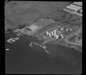 Unidentified factories, Carbine Road industrial area, Mt Wellington, Auckland, featuring commercial jetties on the Tamaki River