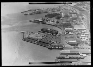 Ships, containers, cranes and warehouses on the wharves at Port of Auckland, Waitemata Harbour, including industrial waterfront area