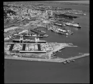 Ships, containers and cranes at Fergusson Wharf, Port of Auckland, Waitemata Harbour, including Auckland Railway Station and City