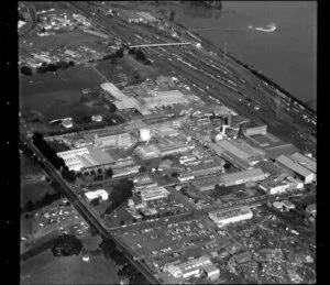 Factories, including Griffith Laboratories, R & W Hellaby Limited, and railway yards and station, in industrial area, Westfield, Manukau City, Auckland